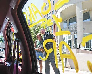 Frank Fordley, left, surprised his longtime friend, Richard McGrath, a Trumbull County Sheriff’s deputy, with a car for his daughter Friday afternoon.