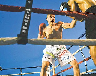 Campbell’s Jake Giuriceo backs Georgia’s Winston Mathis into the corner during their six-round light welterweight bout at Friday’s “Real Deal” boxing show at the Covelli Centre.