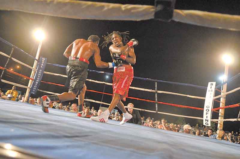 Dannie Williams, right, follows through on a right hook as his opponent, Oscar Cuero, tries to land a right uppercut during Friday’s 10-round lightweight bout outside the Covelli Centre.
