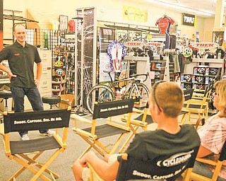 North Lima native and pro cyclist David Wenger speaks with Salem resident and beginner cyclist Chase Howard, 16, at Cycle Sales in Boardman. Wenger, who won the USA Cycling’s 2011 Elite National Championship Criterium event in Augusta, Ga., will race in this weekend’s Tour of the Valley. Howard, who has been racing for about a year, said getting to meet Wenger keeps him inspired.