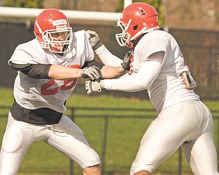 David Rach, left, is ready to suit up again for the Youngstown State University Penguins after a football-free spring semester.