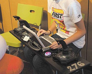 Hallie Duarte, an incoming sophomore at Youngstown Early College, is at the controls of the robot of her team, the 276 Mad Cows, consisting of Youngstown high-school students.