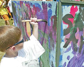 Mason St.Clair, 5, son of Pat and Karen St.Clair of Niles works on a mural at the YSU Summer Arts Festival Saturday. wdlewis
