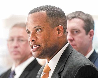 Youngstown, Ohio, Mayor Jay Williams, center, talks to the press following the announcement of his new role as the Director of the Office of Recovery for Autoworkers and Communities by U.S. Secretary of Labor Hilda Solis on Wednesday July 6, 2011, at Diplomat Specialty Pharmacy in Flint, Mich., which was redeveloped from a General Motors auto factory. Williams starts as head the Office of Recovery for Auto Communities and Workers on Aug. 8. He will step down as mayor Aug. 1 and will work in the Labor Department. (AP Photo/The Flint Journal, Ryan Garza) (AP Photo/The Flint Journal, Ryan Garza)