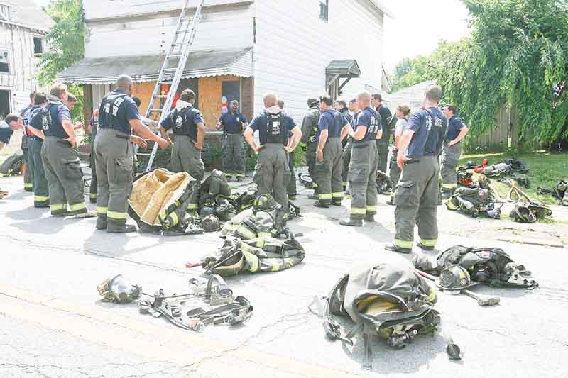 Capt. Barry Finley of the Youngstown Fire Department speaks to members of the city and Liberty fire departments after completing Rapid Intervention Training at an abandoned building on Indianola Avenue on the city’s South Side. The training session Wednesday highlighted points in saving a firefighter trapped in a burning building.