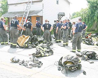 Capt. Barry Finley of the Youngstown Fire Department speaks to members of the city and Liberty fire departments after completing Rapid Intervention Training at an abandoned building on Indianola Avenue on the city’s South Side. The training session Wednesday highlighted points in saving a firefighter trapped in a burning building.