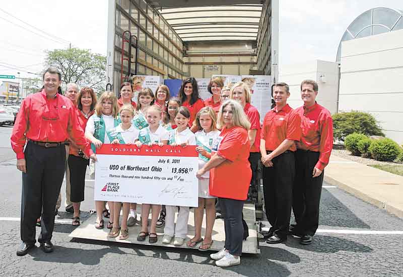 First Place Bank and Mahoning Valley residents raised $13,956 for the United Service Organization of Northeast Ohio. Bank employees and Girl Scout Troop 80129 gathered Wednesday at the Boardman location to pack food, health-care items and letters into boxes to be shipped to soldiers in Afghanistan. 