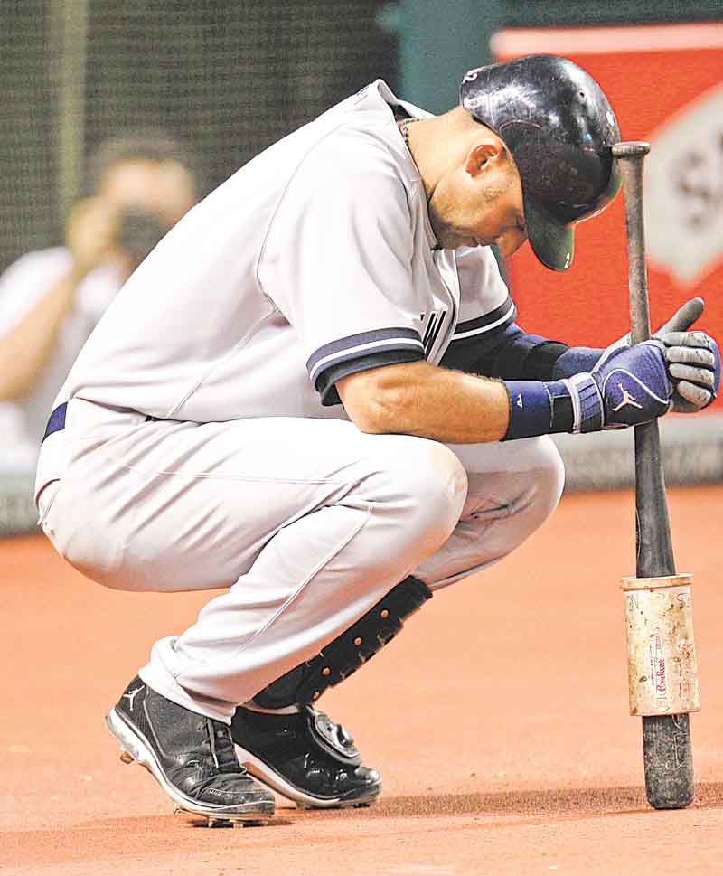 New York Yankees' Derek Jeter waits to bat in the ninth inning in a baseball game against the Cleveland Indians, Wednesday, July 6, 2011, in Cleveland. Jeter did not get a chance to bat in the ninth. Jeter ended the game three away from 3,000 for his career. The Indians won 5-3. (AP Photo/Tony Dejak)
