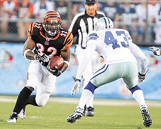 Cincinnati Bengals running back Cedric Benson (32) runs against Dallas Cowboys safety Gerald Sensabaugh (43) in the first quarter of the Hall of Fame NFL football game Sunday, Aug. 8, 2010, in Canton, Ohio. (AP Photo/Mark Duncan)