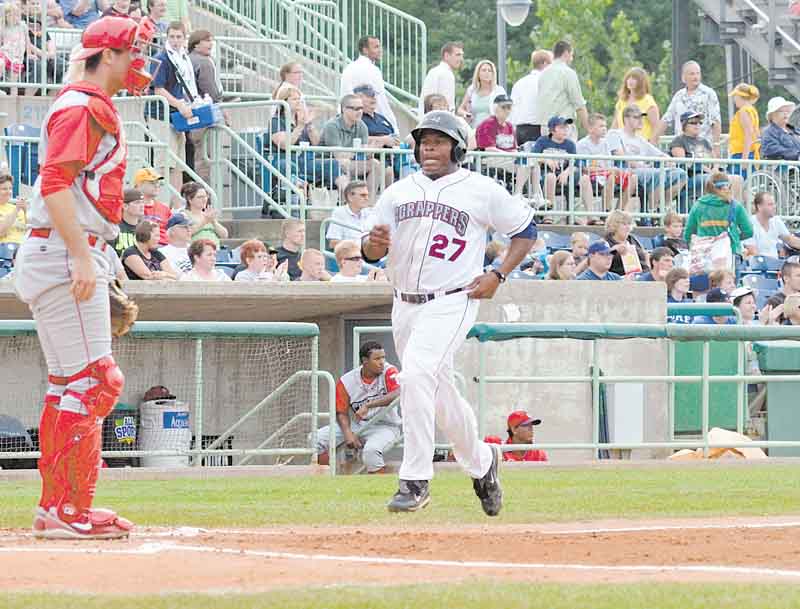 Williamsport catcher Bob Stumpo watches as Mahoning Valley’s Bryson Myles gets ready to cross home plate for the first score of the night at Thursday’s game at Eastwood Field in Niles. The Scrappers defeated the Crosscutters, 8-3.