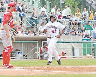 Williamsport catcher Bob Stumpo watches as Mahoning Valley’s Bryson Myles gets ready to cross home plate for the first score of the night at Thursday’s game at Eastwood Field in Niles. The Scrappers defeated the Crosscutters, 8-3.