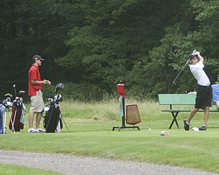 ROBERT K. YOSAY | THE VINDICATOR..Smooth - Max Pikuras tees off on 11 -- watching are Nick Bubon - Bart Wyss and sseated is Joey Canann --The Second Round of qualifiers for the Best Jr. Golfer was held at Tamer Win in Cortland on Friday morning - .. ...-30-