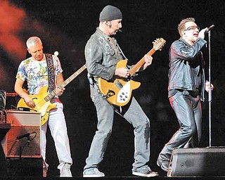 U2 members Adam Clayton, left, The Edge and Bono perform in Miami on June 29. The band’s stadium
tour comes to Pittsburgh’s Heinz Field on July 26.