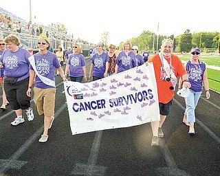 Cancer survivors take the fi rst lap of the evening on Friday to kick off Poland’s Relay for Life fundraiser.