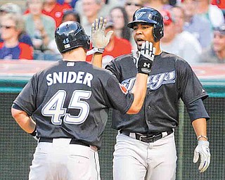 Toronto Blue Jays' Edwin Encarnacion, right, congratulates teammate Travis Snider after Snider drove him in with his two-run home run against Cleveland Indians pitcher Mitch Talbot in the sixth inning of a baseball game in Cleveland on Friday, July 8, 2011. (AP Photo/Amy Sancetta)