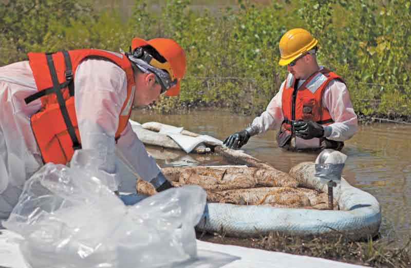 Cleanup workers use oil-absorbent materials alongside the Yellowstone River in Laurel, Mont. An Exxon
Mobil pipeline ruptured and spilled an estimated 1,000 barrels of crude into the Yellowstone last weekend.
