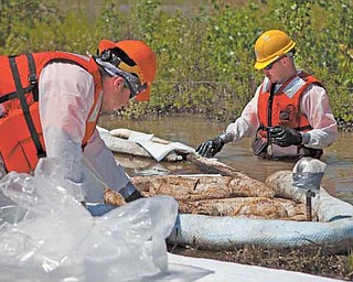 Cleanup workers use oil-absorbent materials alongside the Yellowstone River in Laurel, Mont. An Exxon
Mobil pipeline ruptured and spilled an estimated 1,000 barrels of crude into the Yellowstone last weekend.