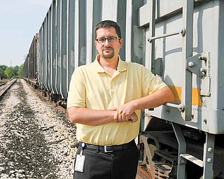 Boardman Township Administrator Jason Loree assesses the amount of trash along the former Youngstown & Southern rail line in the township.