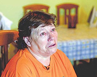 n this Tuesday July 5, 2011 photo Inma Rodriguez holds back tears during an interview with The Associated Press in her home in Alcala de Henares near Madrid. Inma is packing for a trip she dreads. Any day now, for defaulting on her mortgage, she'll be evicted from the apartment where she's lived for 30 years and raised two children. As in many European countries, Spanish mortgages are not like US-style ones in which defaulters can return the keys to the bank and walk away from their debt, albeit with their credit rating in ruins. Here, mortgage holders not only have to give the house back, but also pay off bank debt. If they cannot, upon their death it is passed on to their children. (AP Photo/Paul White)