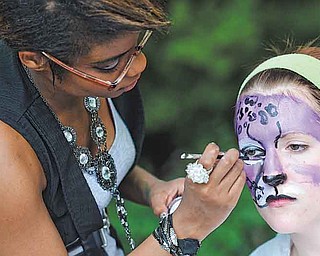 RAMI DAUD | THE VINDICATOR.Alpha Psi Omega Sorority member Brittney Grant paints the face of Kelly Sullivan also of Alpha Psi Omega at a booth at theYSU ArtistsÕ Marketplace outside of the Kilcawley Center Saturday afternoon.