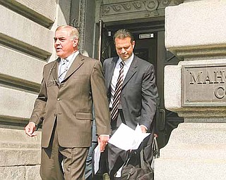 Anthony M. Cafaro Sr., former president of the Cafaro Co., center, emerges from the courthouse with a prepared statement to read to the media. He read the statement Monday after dismissal of all charges against him in the Oakhill Renaissance Place criminal conspiracy case. He is flanked by his lawyers, Martin G. Weinberg of Boston, left, and George A. Stamboulidis of New York City.