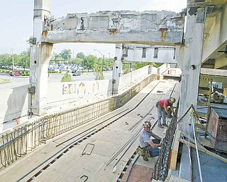 Work continues on the Youngstown State University parking deck on Lincoln Avenue. Plans are for renovation of the 1971 structure to be finished in time for the start of fall classes Aug. 29.