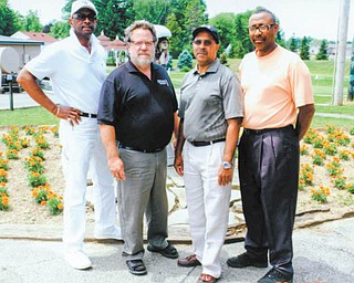 Youngstown Golf Club members are kicking off an annual golf outing in memory of Dr. Earnest Perry to provide scholarships to medical students. Those involved are, from left to right, George Ross, president of Youngstown Golf Club; John Russo, a professor at Youngstown State University; George Williams, owner of Goldie’s Flowers; and Phil Smith of Choice Homes.
