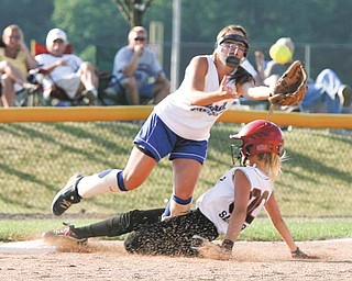 Canfi eld outfi elder Allie Samarco safely steals third base as Poland third baseman Gina Ungaro fi elds the ball during the bottom of the second inning Tuesday against the Bulldogs. The Cardinalswon 11-5 to gain the Little League Ohio District 2 championship.