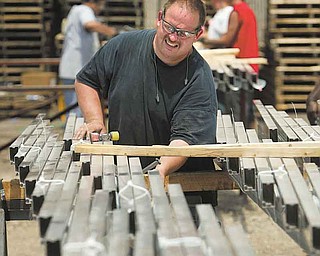 John Cheeks of Niles prepares a load of solar flex rack frames for shipping at Northern States Metals Co., located on the Youngstown’s West Side.