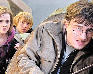 In this film publicity image released by Warner Bros. Pictures, from left, Emma Watson, Rupert Grint and Daniel Radcliffe are shown in a scene from "Harry Potter and the Deathly Hallows: Part 2." (AP Photo/Warner Bros. Pictures, Jaap Buitendijk)