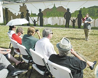 Artist Briar Rantilla of Warren speaks during a dedication ceremony for a mural of downtown Warren that he
created on a building at 310 Elm Road NE in Warren.