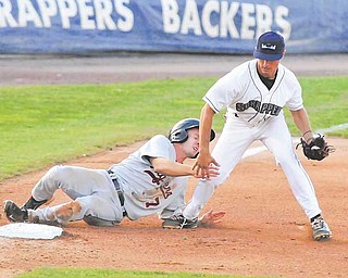 Mahoning Scrappers third baseman KC Serna hangs on to the ball as Connecticut Tigers baserunner Colin Kaline tries to take him out with a slide during their New York-Penn League baseball game Thursday at Eastwood Field in Niles. The Scrappers rallied from a four-run defi cit, scoring five runs in the sixth inning and going on to defeat the Tigers, 9-6.