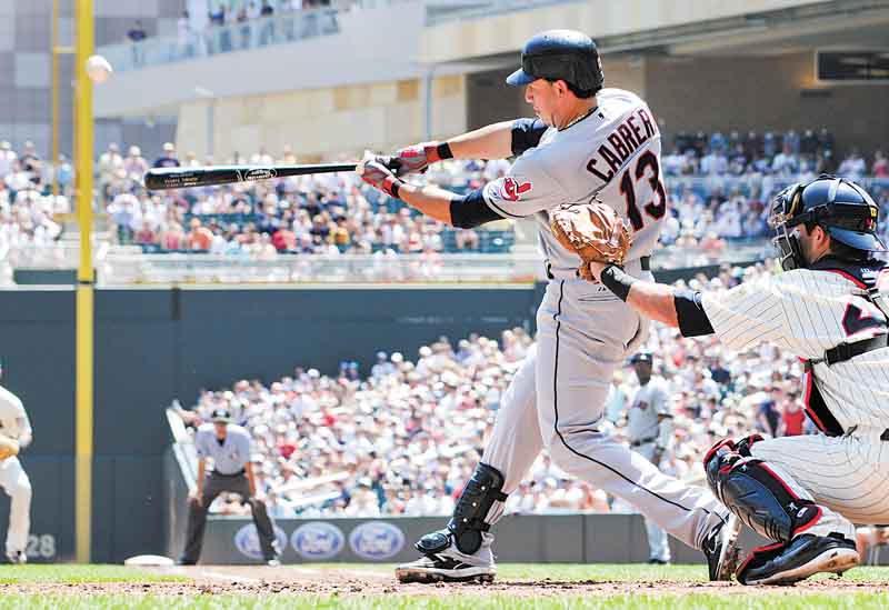 Cleveland Indians' Asdrubal Cabrera hits a three-run home run off Minnesota Twins pitcher Anthony Swarzak in the third inning of the first baseball game of a doubleheader Monday, July 18, 2011 in Minneapolis. Catching is Twins' Drew Butera. (AP Photo/Jim Mone)