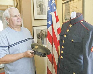 William d Lewis the Vindicator  Ken Miller Trusteeof the Girard Historical Society, shows a Marine uniform on display at the Barnhisel House in Girard as part of military uniform exhibit.7-18-11.