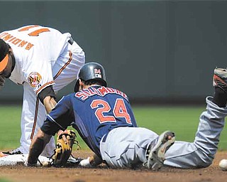 Cleveland Indians' Grady Sizemore (24) slides into second with a double in front of Baltimore Orioles second baseman Robert Andino (11) during the first inning of a baseball game, Sunday, July 17, 2011, in Baltimore. Sizemore left the game with an injury on the play. (AP Photo/Nick Wass)