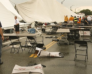 ROBERT K. YOSAY | THE VINDICATOR..A late afternoon summer thunderstorm hit the southside of Youngstown - taking down limbs, trees and knocking out electric -  the RIBFEST at the Covelli Centre had several people injured when tents were blown down ...-30-