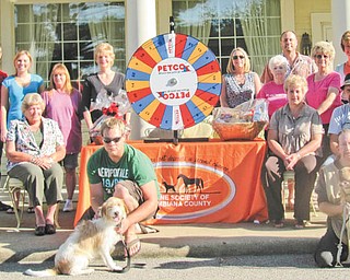 The committee for the 2011 ROCC and Rescue Reverse Raffle comprises, from left to right in front, Nate Johnson with Holly, a victim of severe neglect, and Scott Snyder with Judge. In the second row are Atty. Amanda Jackson, Atty. Barb Plummer, and Dessie and Bob Bates, and in the back are Dylan Paumier, Nickole Davis, Darla Miller, JayDee Pamer, Lisa Shoff, Sally Geary, Carey Shoff, Darlene Jenkins, Jenny Pike and Lora Herbert. Missing from the photo are Dr. Vickey Brooks, Lisa Keller and Heather Jurina.