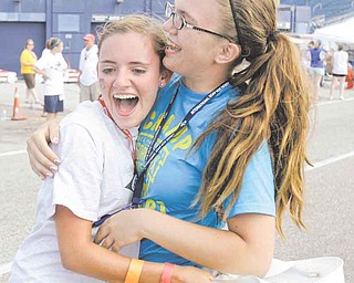 Megan Frantz, left, hugs her friend, Ashley Hiller after Frantz won the Masters championship race at the 74th All-American Soap Box Derby Saturday, July 23, 2011, in Akron, Ohio. Frantz, 16, is from New Philadelphia, Ohio. (AP Photo/Tony Dejak)