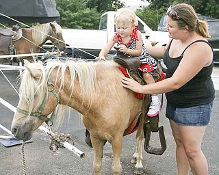 Kaylee Trolio, 2, of Boardman goes for a pony ride as her mother, Lizzie Padgitt, walks beside her at the Mount Carmel Italian Festival on Saturday. The annual festival opens at 1 p.m. today and concludes this evening at 10.