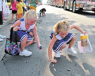 Mikayla Jumper and Mikenzie Jumpber of Hubbard pick up candy during the Family Funday Parade in Hubbard Saturday afternoon.