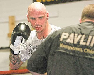 Kelly Pavlik works out at the South Side Boxing Club with trainer Jack Loew in Youngstown on July 20, 2011.