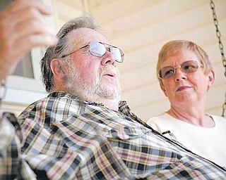 In this June 6, 2011 photo, Ray and Jo Kelly relax on a swing in front of their home in Conklin, Mich., where they live in retirement. The two both take Lipitor and look forward to having extra money when the drug is replaced with a generic in the fall. (AP Photo/Adam Bird)