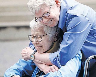 Phyllis Siegel, 77, left, and Connie Kopelov, 85, both of New York, embrace after becoming the first same-sex couple to get married at the Manhattan City Clerk's office, Sunday, July 24, 2011, in New York.