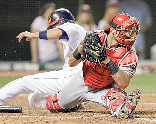 Los Angeles Angels catcher Jeff Mathis catches the throw to force the Cleveland Indians' Orlando Cabrera out at the plate in the ninth inning of Monday’s baseball game in Cleveland. One batter later, Jason Kipnis drove in the winning run for the Tribe with his fi rst major league hit. The final score was Cleveland 3, Los Angeles 2.