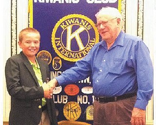 Chuck Whitman, right, president of the Kiwanis Club of Youngstown, greets Brian Terlesky, 11, a world-ranked junior golfer from Boardman, who recently visited the club. Brian recently shared with club members his experiences golfing around the country and the world.