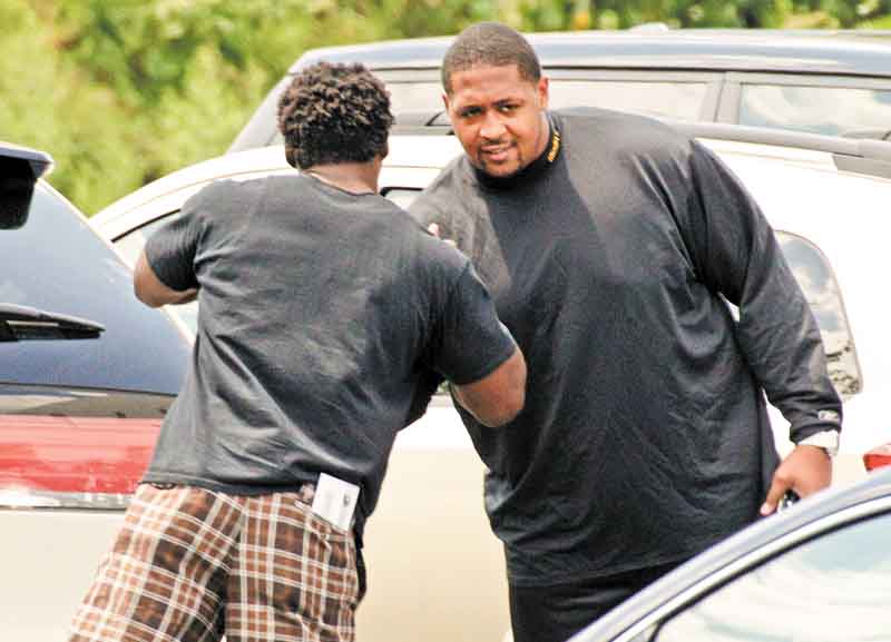 Pittsburgh Steelers running back Rashard Mendehall, left, greats offensive lineman Ramon Foster in the parking lot of the team's football training facility in Pittsburgh, Tuesday, July 26, 2011, the day after the NFL lockout ended.  (AP Photo/Gene J. Puskar)