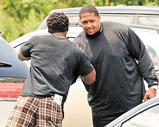 Pittsburgh Steelers running back Rashard Mendehall, left, greats offensive lineman Ramon Foster in the parking lot of the team's football training facility in Pittsburgh, Tuesday, July 26, 2011, the day after the NFL lockout ended.  (AP Photo/Gene J. Puskar)