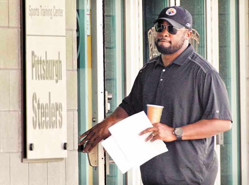Pittsburgh Steelers coach Mike Tomlin arrives at the NFL football team's training facility in Pittsburgh on Tuesday, July 26, 2011. (AP Photo/Gene J. Puskar)
