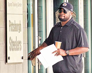 Pittsburgh Steelers coach Mike Tomlin arrives at the NFL football team's training facility in Pittsburgh on Tuesday, July 26, 2011. (AP Photo/Gene J. Puskar)