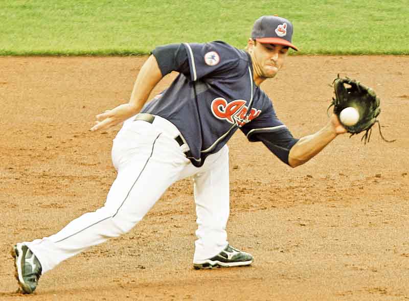 Cleveland Indians third baseman Jack Hannahan tracks down a ground ball by Los Angeles Angels' Jeff Mathis during the third inning of a baseball game, Tuesday, July 26, 2011, in Cleveland. Hannahan threw Mathis out at first. (AP Photo/Mark Duncan)
